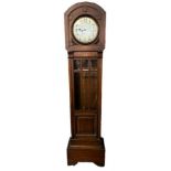 AN ART DECO PERIOD OAK GRANDMOTHER CLOCK With a silvered dial and Westminster chimes movement,