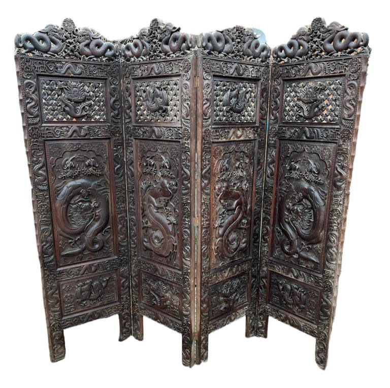 A LARGE LATE 19TH/EARLY 20TH CENTURY CHINESE HARWOOD FOUR FOLD SCREEN Heavily carved to both sides