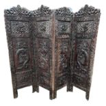 A LARGE LATE 19TH/EARLY 20TH CENTURY CHINESE HARWOOD FOUR FOLD SCREEN Heavily carved to both sides