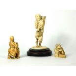 A 19TH CENTURY CHINESE IVORY OKIMONO FIGURE, AN ELDERLY FIGURE IN STANDING FIGURE Carrying a