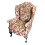 AN EARLY 20TH CENTURY GEORGIAN STYLE CHILDS WING ARMCHAIR The later fabric upholstery figured with