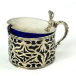 A LARGE GEORGIAN SILVER AND BLUE GLASS SPHERICAL MUSTARD POT With hinged lid and pierced scrolls