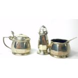 AN EARLY 20TH CENTURY SILVER AND BLUE GLASS THREE PIECE CRUET SET Comprising a hinged mustard pot