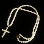 AN EARLY 20TH CENTURY 9CT GOLD AND SEED PEARL CRUCIFIX NECKLACE The single strand of pearls with a