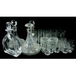A COLLECTION OF VINTAGE CUT GLASS DECANTERS AND GLASSES Comprising two ships decanters, ewer, brandy