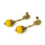 A PAIR OF YELLOW METAL AND ENAMEL DROP EARRINGS Set with black and white enamel and a spherical