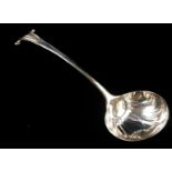 A GEORGIAN SILVER LADLE Having a scroll finial and shell form bowl, engraved with family crest to
