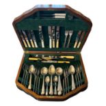 PINDER BROTHERS, A 1930'S BURR WALNUT CASED SHEFFIELD STAINLESS STEEL CANTEEN OF CUTLERY Having a