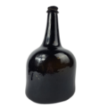 AN EARLY 18TH CENTURY MALLET FORM DARK GLASS BOTTLE Having original metal stopper/seal, marked '