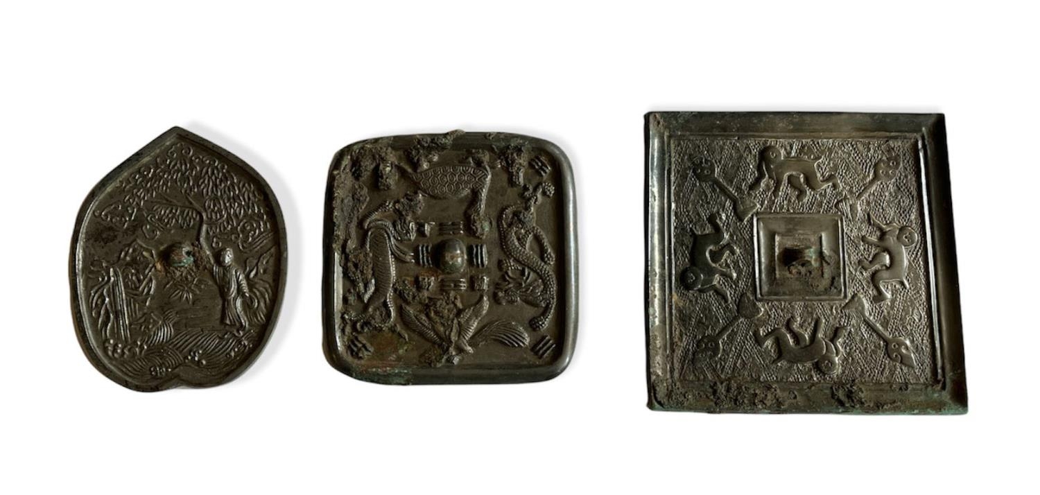 TWO SQUARE ARCHAISTIC BRONZE MIRRORS Along with another of leaf form. (largest w 16cm)