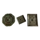 TWO ROUND ARCHAISTIC BRONZE MIRRORS Along with a square mirror and an oblong mirror. (largest w