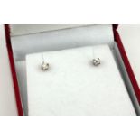 A PAIR OF 20TH CENTURY 18CT GOLD AND DIAMOND EARRINGS Each set with a round cut diamond, in a fitted