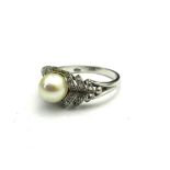 A MID 20TH CENTURY 18CT WHITE GOLD, DIAMOND AND PEARL RING The single pearl in a pierced geometric
