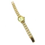 ZENITH, A VINTAGE 9CT GOLD LADIES WRISTWATCH Having a rectangular dial with calendar window, on an