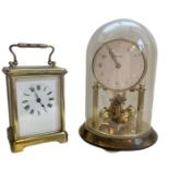 AN EARLY 20TH CENTURY GILT BRASS CARRIAGE CLOCK The white enamel dial with Roman numerals,