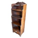 A 19TH CENTURY MAHOGANY WATERFALL BOOKCASE With open shelves above a single drawer, raised on