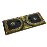 A LATE VICTORIAN LACQUER EBONISED BOOK ENDS The gilt border and mother of pearl applique decoration,