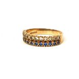 A VINTAGE 9CT GOLD, DIAMOND AND SAPPHIRE HALF ETERNITY RING Having a single row of round cut