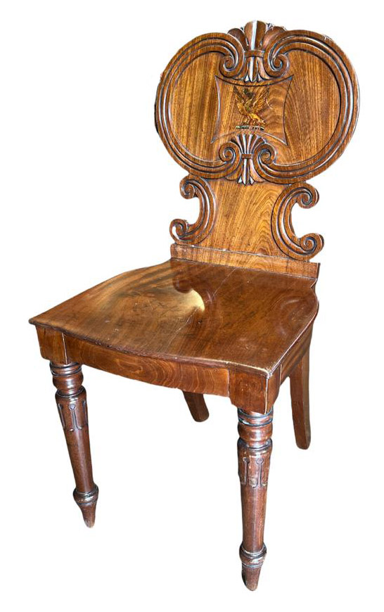 A REGENCY MAHOGANY HALL CHAIR The central back panel painted with a winged Phoenix above a solid