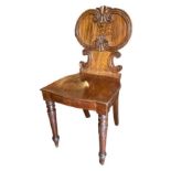 A REGENCY MAHOGANY HALL CHAIR The central back panel painted with a winged Phoenix above a solid