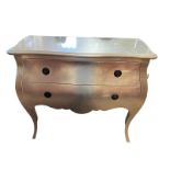 A CONTINENTAL SILVERED BOMBE SHAPED COMMODE With two drawers above a shaped apron, on square
