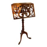 A VICTORIAN MAHOGANY ADJUSTABLE DUET MUSIC STAND The pierced fretwork rests and adjustable turned