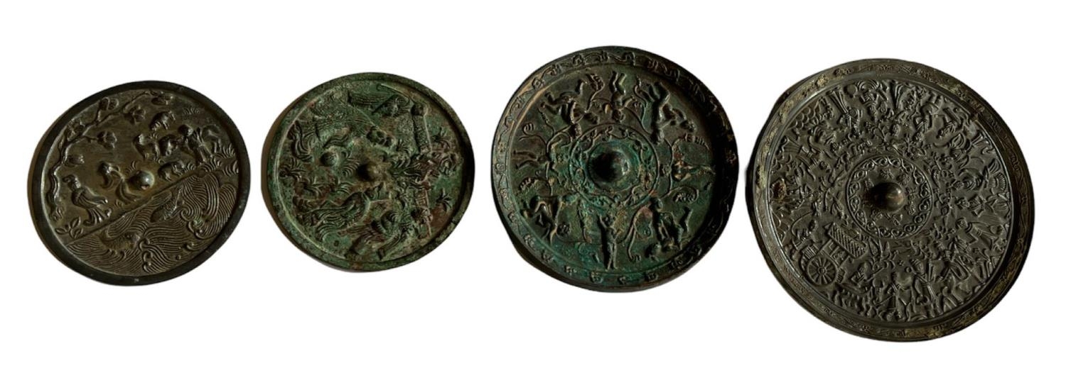 FOUR ASSORTED CIRCULAR ARCHAISTIC BRONZE CHINESE MIRRORS. (largest w 21.5cm)