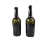 TWO MID 18TH CENTURY DARK GLASS CYLINDER WINE BOTTLES Moulded with circular medallion depicting a