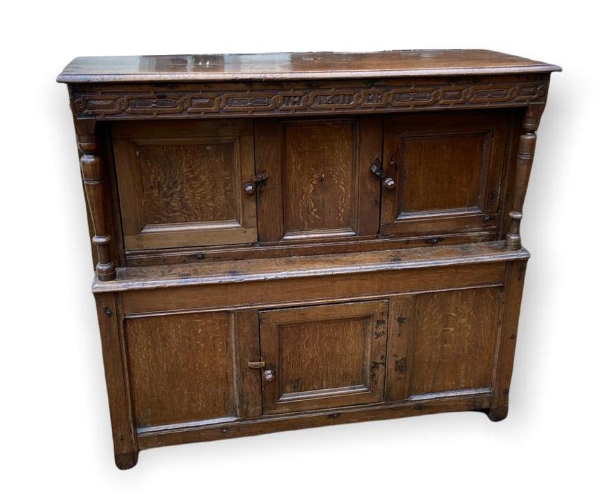 A 17TH CENTURY AND LATER OAK COURT CUPBOARD The carved frieze bearing initials 'IH' and 'MH 1611'