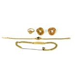A COLLECTION OF VINTAGE YELLOW METAL JEWELLERY Comprising an identity bracelet, a bracelet set