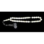 A 19TH CENTURY TURKISH OTTOMAN SILVER AND IVORY NECKLACE The single strand of spherical ivory beads,