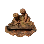 A 20TH CENTURY HIGHLY DECORATIVE VICTORIAN STYLE TERRACOTTA GARDEN FOUNTAIN Supported by two