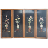 A SET OF FOUR CHINESE HARDSTONE WOOD FRAMED WALL PLAQUES On a black ground with metal hooks,