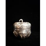 AN ASIAN WHITE METAL FIGURAL BOX Modelled as an apple with embossed cartouches of deities, marked '