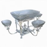 A SILVER PLATED AND CUT GLASS CENTERPIECE With sectional dishes, standing on four branches. (h 30cm,