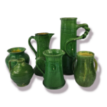 ARTS & CRAFTS, A MIXED SELECTION OF FOUR INSPIRED GREEN GLAZED JUGS Three loop handled vases, with a