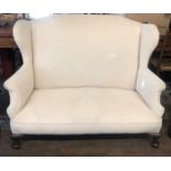 AN EARLY 20TH CENTURY TWO SEAT WING SETTEE In cream fabric upholstery, on squat cabriole legs. (w