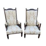 A PAIR OF EDWARDIAN WALNUT OPEN ARMCHAIRS In later floral fabric upholstery, on turned legs. (68cm x