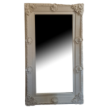 A LARGE DECORATIVE REGENCY STYLE BEVELLED PLATE MIRROR The cream frame with shell cartouches. (110cm