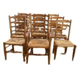 A MATCHED SET OF NINE INCLUDING ONE CARVER EARLY 20TH CENTURY HONEY OAK NORTH COUNTRY LADDER BACK