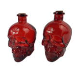 A PAIR OF RUBY GLASS SKULL BOTTLES AND STOPPERS. (h 17.5cm) Condition: good overall