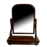 A VICTORIAN MAHOGANY DRESSING TABLE MIRROR The arched top and swivel mirror on scrolled flame