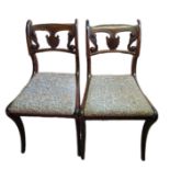 A PAIR OF REGENCY MAHOGANY STANDARD CHAIRS With pierced shell and scroll backs and upholstered