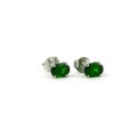 A PAIR OF SILVER CHROME DIOPSIDE STUDS.
