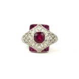 A VICTORIAN STYLE RUBY AND DIAMOND DRESS RING with a pierced ornate setting set in platinum.