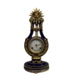 A LOUIS VXI STYLE POTTERY AND GILT METAL MOUNTED LYRE CLOCK Striking on bell, white dial inscribed