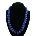 A ROUND CARVED BLUE ONYX 2 STRAND AJUSTABLE BEAD NECKLACE.
