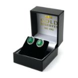 A PAIR OF 18CT WHITE GOLD OVAL EMERALD AND DIAMOND CLUSTER STUDS. (Emeralds 3.82ct, Diamonds 0.78ct)