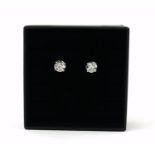 A PAIR OF 18CT WHITE GOLD FOUR CLAW ROUND BRILLIANT CUT DIAMOND STUDS. (Diamonds 1.32ct) Boxed.