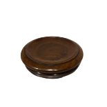 AN EARLY 19TH CENTURY CIRCULAR SOLID FLAME MAHOGANY CHEESE COASTER Raised on three brass casters. (h